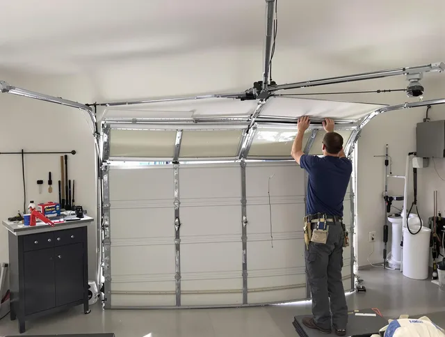 Norton Garage Door Repair specialist performing precise section replacement on Norton garage door
